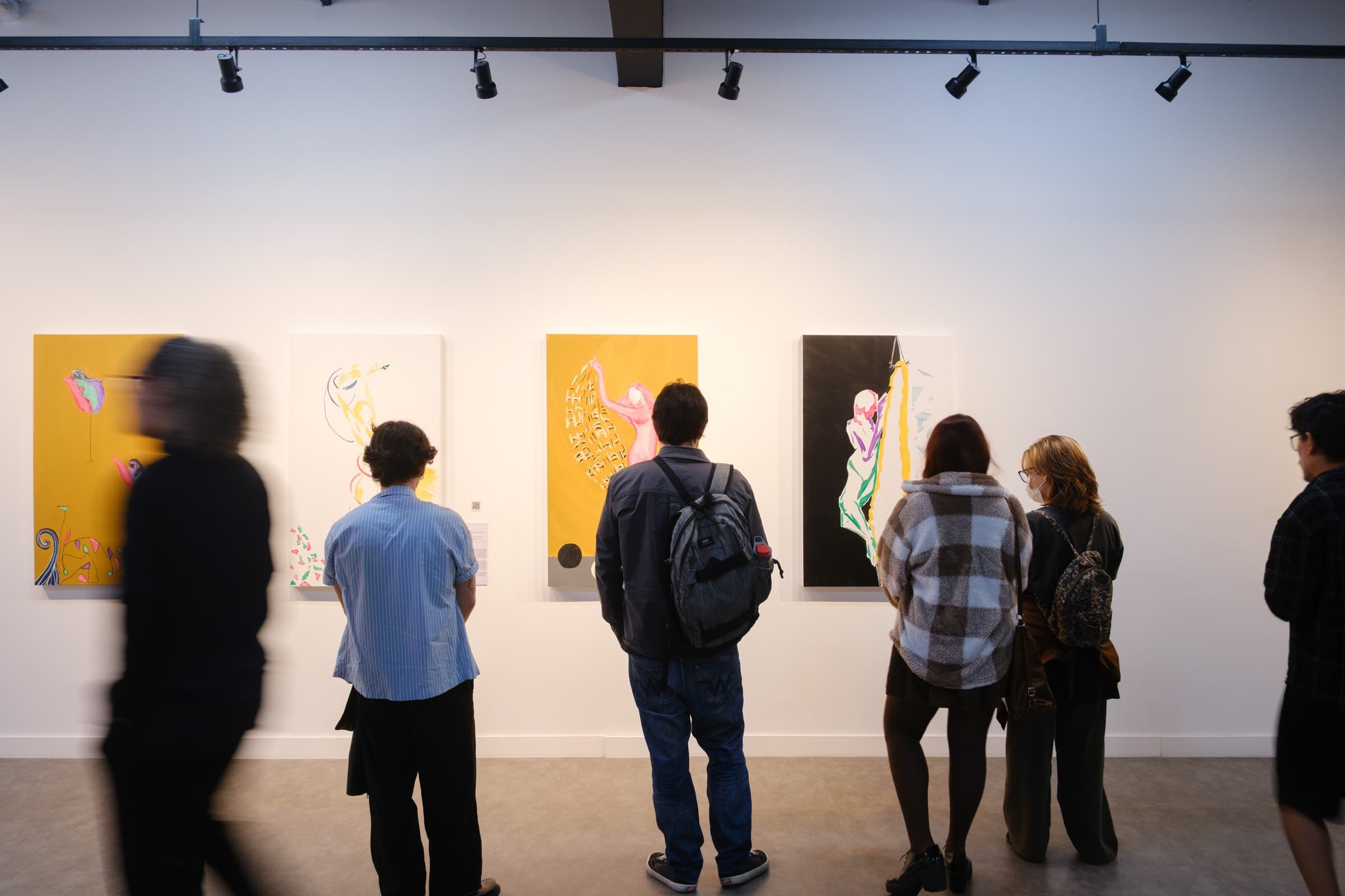 Visitors spending time with the paintings